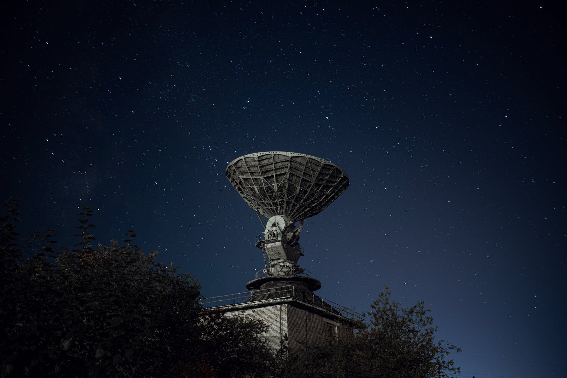satellite antenna on structure under starry sky